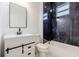 Elegant bathroom with dark hardware, double vanity and tiled shower and tub at 158 Chickering St, Port Charlotte, FL 33954