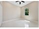 Bright bedroom with tile floors and a large window overlooking the neighborhood at 158 Chickering St, Port Charlotte, FL 33954