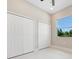 Bedroom featuring bright window for natural light, tiled floors and double door closet at 158 Chickering St, Port Charlotte, FL 33954