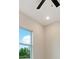 Bright bedroom featuring a ceiling fan and a window with scenic outdoor views at 158 Chickering St, Port Charlotte, FL 33954