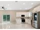 Bright, open kitchen with stainless steel appliances, white cabinets, and sliding door access to the backyard at 158 Chickering St, Port Charlotte, FL 33954