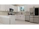 Modern kitchen featuring stainless steel appliances, white cabinets, and sleek countertops at 158 Chickering St, Port Charlotte, FL 33954