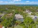 Aerial view of a beautiful home with a screened pool surrounded by lush landscaping at 1693 Landings Ln, Sarasota, FL 34231
