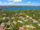 Aerial shot overlooking a neighborhood with water views, and tree coverage at 1693 Landings Ln, Sarasota, FL 34231