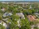 An overhead view showcases a private residence encircled by mature trees, offering seclusion at 1693 Landings Ln, Sarasota, FL 34231