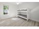 Bright bedroom with a bunk bed, ceiling fan, and plank floors at 1693 Landings Ln, Sarasota, FL 34231