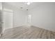 Bright bedroom featuring wood-look floors, ceiling fan, and neutral paint at 1693 Landings Ln, Sarasota, FL 34231
