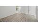 Bedroom featuring a window, wood-look floors, and a walk-in closet at 1693 Landings Ln, Sarasota, FL 34231