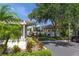 Charming clubhouse exterior surrounded by mature landscaping and tropical foliage at 1693 Landings Ln, Sarasota, FL 34231