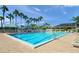 Resort-style community pool with lounge chairs and tall palm trees at 1693 Landings Ln, Sarasota, FL 34231