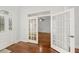 Entryway with hardwood floors and glass-paned french doors at 1693 Landings Ln, Sarasota, FL 34231