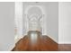 Elegant foyer with hardwood floors, high ceilings, arched entryways, and a view of the front doors at 1693 Landings Ln, Sarasota, FL 34231