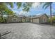 Charming home featuring a paved driveway, lush landscaping, and a welcoming entryway at 1693 Landings Ln, Sarasota, FL 34231