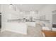 Spacious kitchen with custom cabinets, tile backsplash, and center island at 1693 Landings Ln, Sarasota, FL 34231