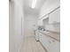 Bright laundry room with washer, dryer, cabinets, and sink at 1693 Landings Ln, Sarasota, FL 34231
