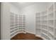 Large walk-in closet with custom shelving and hardwood floors at 1693 Landings Ln, Sarasota, FL 34231