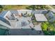 Aerial view of an outdoor patio with a dining table, grill, hot tub, and manicured garden at 1755 7Th St, Sarasota, FL 34236