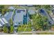 Aerial view of modern flat-roofed home with solar panels next to traditional style gabled home in lush, green neighborhood at 1755 7Th St, Sarasota, FL 34236