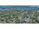 An aerial view of a modern home nestled in a tree-lined neighborhood near downtown, with water views at 1755 7Th St, Sarasota, FL 34236