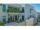 The backyard patio features plenty of seating and a second-story balcony with greenery at 1755 7Th St, Sarasota, FL 34236