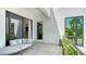 Private balcony with seating, natural light, and a view of lush greenery at 1755 7Th St, Sarasota, FL 34236