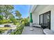 Stylish balcony with an umbrella, comfortable seating, and a view of the lush neighborhood at 1755 7Th St, Sarasota, FL 34236