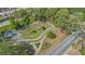 Aerial view of a dog park with a shaded picnic area, walking paths, and green space, perfect for pet owners at 1755 7Th St, Sarasota, FL 34236