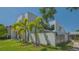 Contemporary two-story home with black framed windows and lush green palm trees at 1755 7Th St, Sarasota, FL 34236