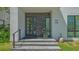 Modern home entrance with stone steps and a sleek glass-paneled front door at 1755 7Th St, Sarasota, FL 34236