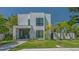 A contemporary two-story home features clean lines, modern windows, and a well-manicured lawn at 1755 7Th St, Sarasota, FL 34236