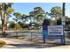 Gillespie Park featuring a playground, swings, trees, and a park sign, offering a recreational space for families and children at 1755 7Th St, Sarasota, FL 34236