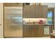Modern kitchen features stainless steel refrigerator, brown cabinets, under cabinet lights and beverage cooler at 1755 7Th St, Sarasota, FL 34236