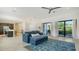 Spacious living room with blue sofa, tile flooring, and glass doors to outside at 1755 7Th St, Sarasota, FL 34236