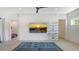 Living room with large wall mounted television, blue couch, and view into bedroom at 1755 7Th St, Sarasota, FL 34236