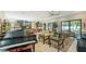 Open-concept living area with a sleek piano, modern furniture, and access to an outdoor area at 1755 7Th St, Sarasota, FL 34236