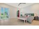 Sunlit primary bedroom showcasing a large window, stylish bedding, and tiled floors at 1755 7Th St, Sarasota, FL 34236