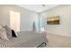 Modern bedroom features neutral tones, patterned bedding and an ensuite bathroom at 1755 7Th St, Sarasota, FL 34236
