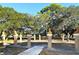 Park view featuring bronze sculptures atop pedestals lining a walkway and mature trees in the background at 1755 7Th St, Sarasota, FL 34236