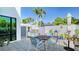 This lovely outdoor patio features a dining table, grill, and view of the palm trees at 1755 7Th St, Sarasota, FL 34236