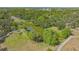 Aerial view of a tranquil pond surrounded by lush trees and greenery, providing a serene park setting for residents at 1755 7Th St, Sarasota, FL 34236