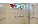 An accessible shower with decorative mosaic tiled floor and colorful artwork at 1755 7Th St, Sarasota, FL 34236