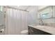 The bathroom has a modern vanity with tile backsplash, a toilet, and a shower with a decorative curtain at 1765 7Th St, Sarasota, FL 34236
