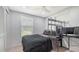 The bedroom has tile floors, a built-in closet, and a large window for natural light at 1765 7Th St, Sarasota, FL 34236