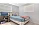 Well-lit bedroom with tile floors, neutral paint, and a large window for natural light at 1765 7Th St, Sarasota, FL 34236