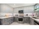 Bright kitchen with stainless steel appliances, light countertops, and modern cabinetry at 1765 7Th St, Sarasota, FL 34236