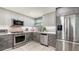 Modern kitchen featuring stainless steel appliances and sleek, two-tone cabinetry at 1765 7Th St, Sarasota, FL 34236