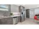 Modern kitchen design featuring stainless steel appliances, grey cabinetry, and light countertops at 1765 7Th St, Sarasota, FL 34236