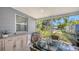Covered patio with tile floors and a dining table offers serene outdoor living space at 1765 7Th St, Sarasota, FL 34236