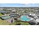 Extensive aerial view of neighborhood featuring a pool, sports courts, a playground, and manicured landscaping at 17676 Savory Mist Cir, Bradenton, FL 34211