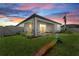 Backyard featuring a well-maintained lawn and covered patio with a slider for easy indoor-outdoor living at 17676 Savory Mist Cir, Bradenton, FL 34211